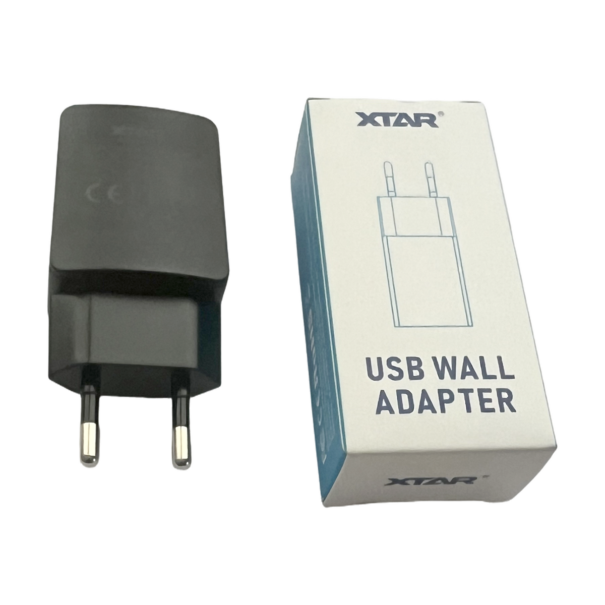 XTAR EU USB power adapter beside its original retail box on a white background.