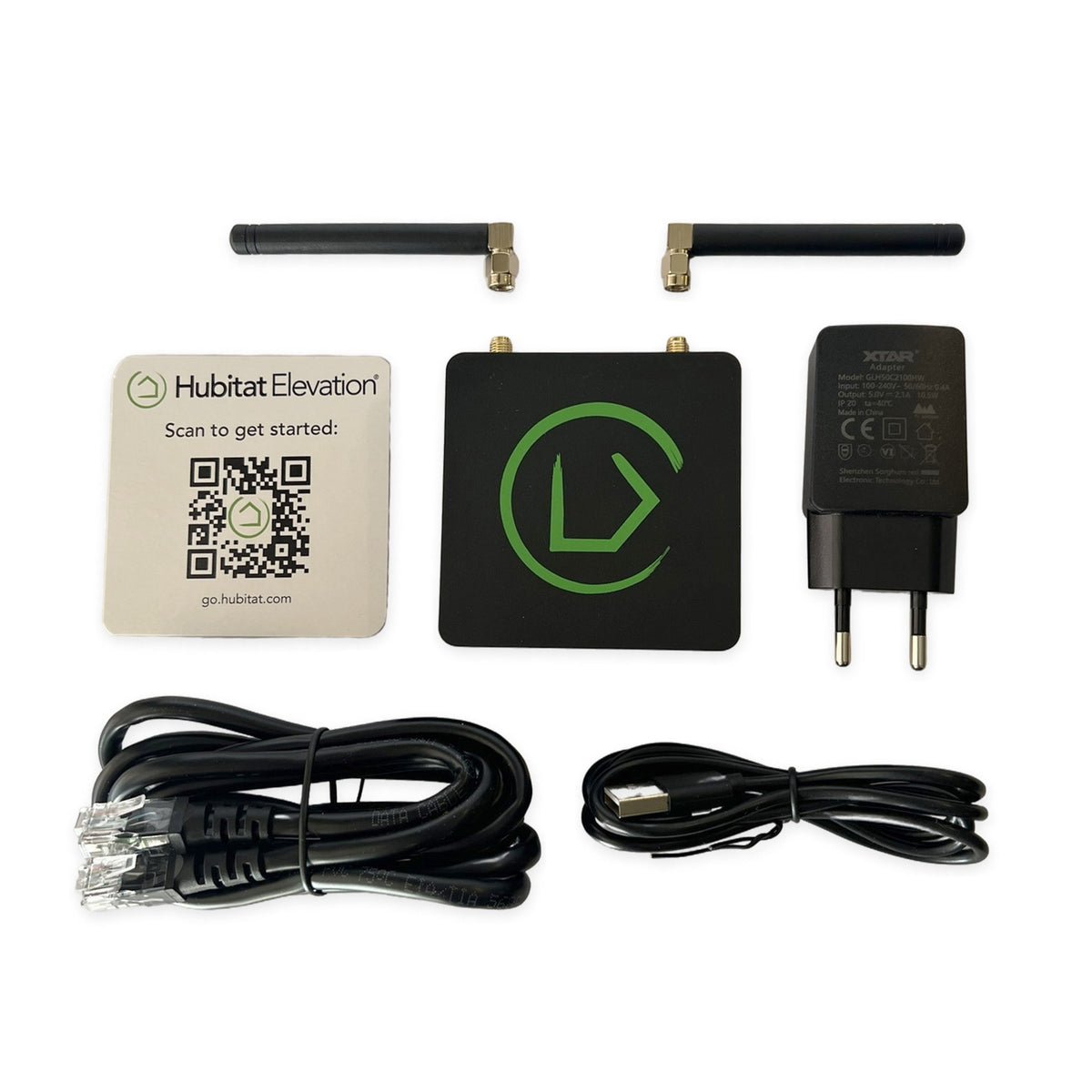 Hubitat Unboxed kit arranged on a white background with hub, two aligned antennas, EU power adapter, Ethernet cable, USB cable and setup card.